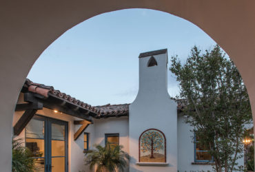 spanish colonial style home featuring a private courtyard