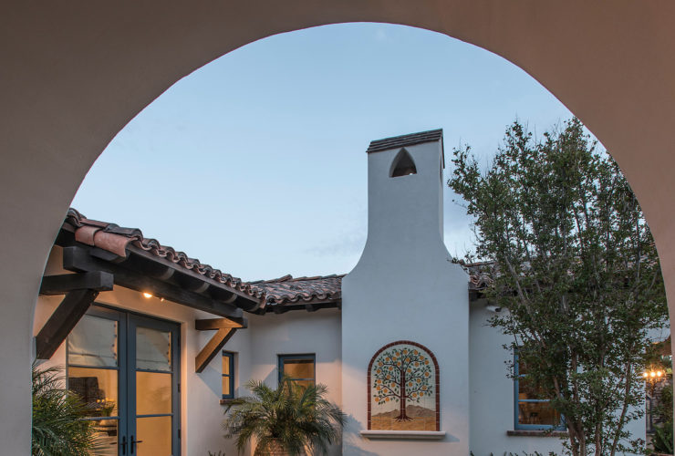 spanish colonial style home featuring a private courtyard