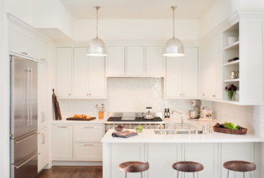 kitchen peninsula with caesarstone countertops and modern low back stools seating