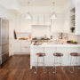 kitchen peninsula with caesarstone countertops and modern low back stools seating
