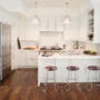 kitchen peninsula with caesarstone countertops and modern low back stools seating