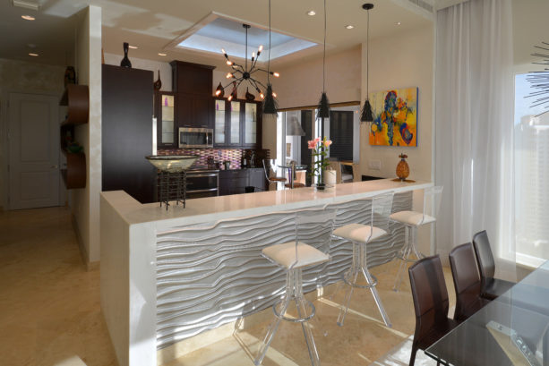 kitchen peninsula with waterfall marble countertop with high back stools seating