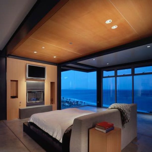 modern room with a wooden frame bed in the middle