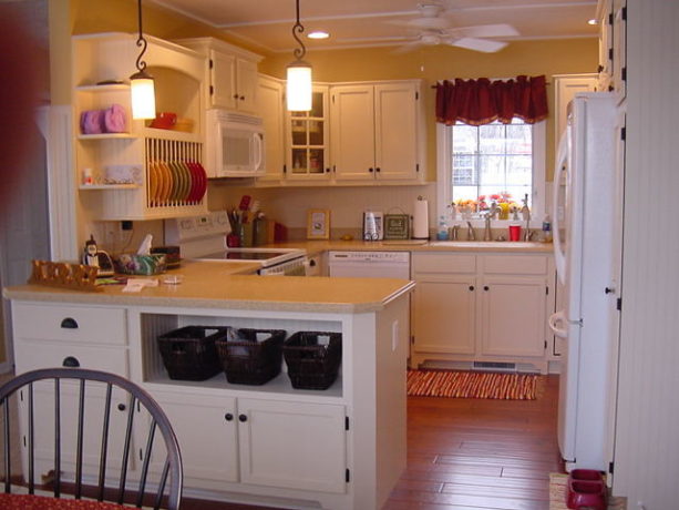 super tiny u-shaped kitchen with a peninsula and white appliances