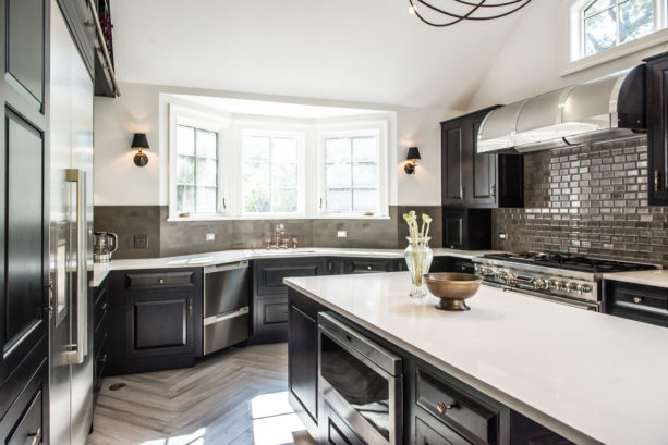 u-shaped kitchen with bay windows over a single bowl sink