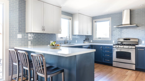 u-shaped kitchen with blue shaker cabinets and a peninsula