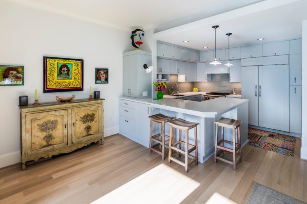 white quartz countertops kitchen peninsula with scandinavian stools seating