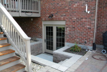 2 panel bi-fold walkout basement door option in a red brick wall