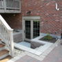 2 panel bi-fold walkout basement door option in a red brick wall