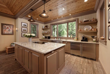 beige kitchen color mixed with light brown raised-panel cabinets to achieve a homey feeling