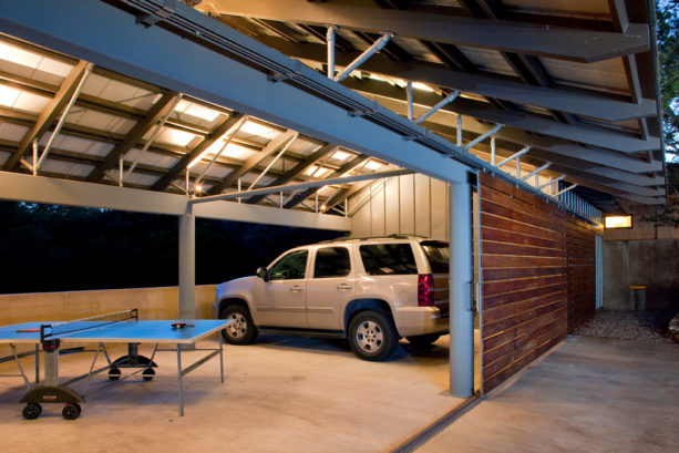 medium tone wood side sliding door in an industrial garage