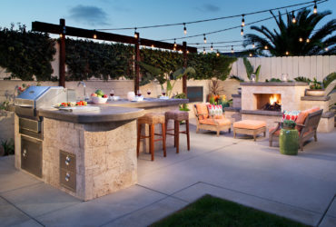 tropical l-shaped outdoor kitchen patio completed with a gas fireplace