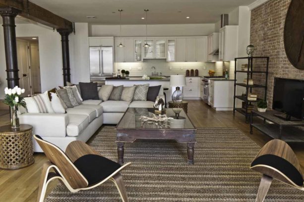 white trendy kitchen with industrial living room combo