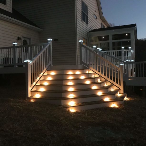 combination of solar post caps and outdoor stair lighting in a deck