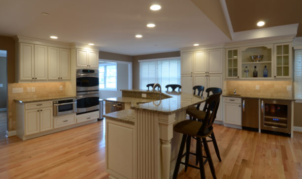 l-shaped two-level kitchen island with granite countertops