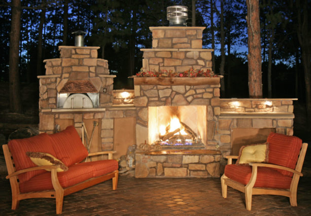 stone veneer fireplace with a traditional-style pizza oven
