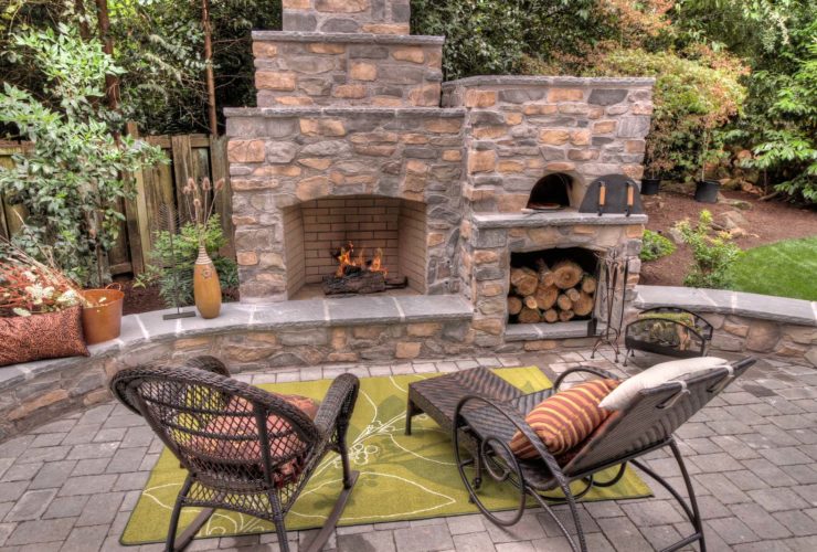 three-tiered outdoor fireplace with a wood-burning pizza oven on its side