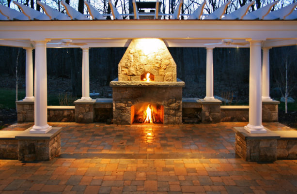 united but separated stone surround outdoor fireplace and pizza oven