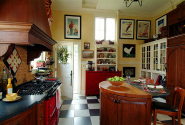 combination of black and white tile kitchen floor with the cherry wood element