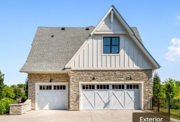farmhouse garage with a bonus room as a laundry space above