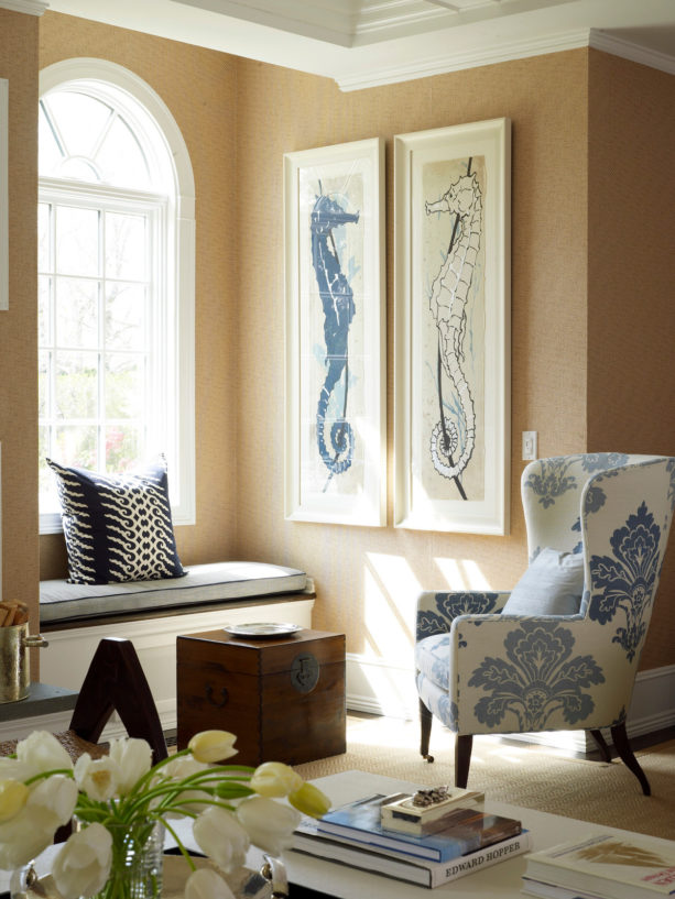 transitional living room with soft orange wall and blue accent