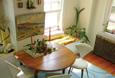 curvy drop leaf dining table against the wall