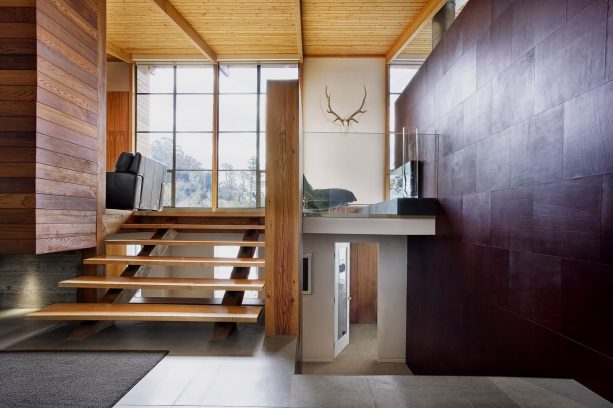 dividing two split levels with an open wooden staircase as a modern house interior