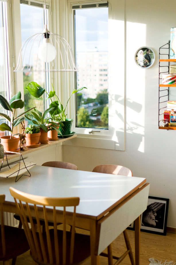 extendable dining table with white top against the wall