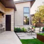 timeless concrete patio in a small backyard as a bbq area