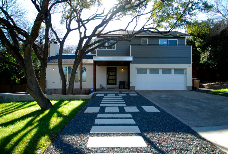 transitional landscaping with black pea gravel walkway and mixed shapes of stepping stones