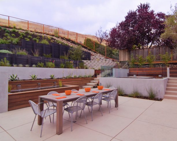concrete and wood retaining wall completed with water feature