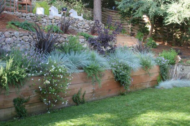 horizontal slab of woods as a retaining wall in a contemporary landscape