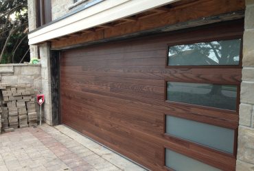 dark mahogany plank garage door with long panel frosted glass