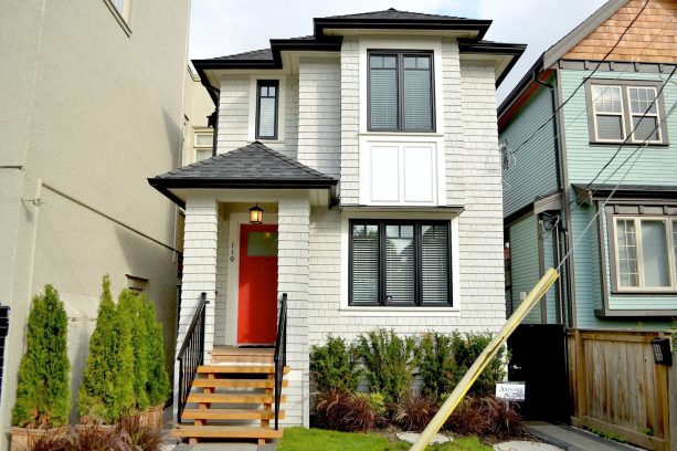 coral front door and black and white color scheme