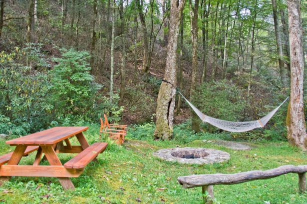 laid-back styled landscape with a rustic look completed with a fire pit
