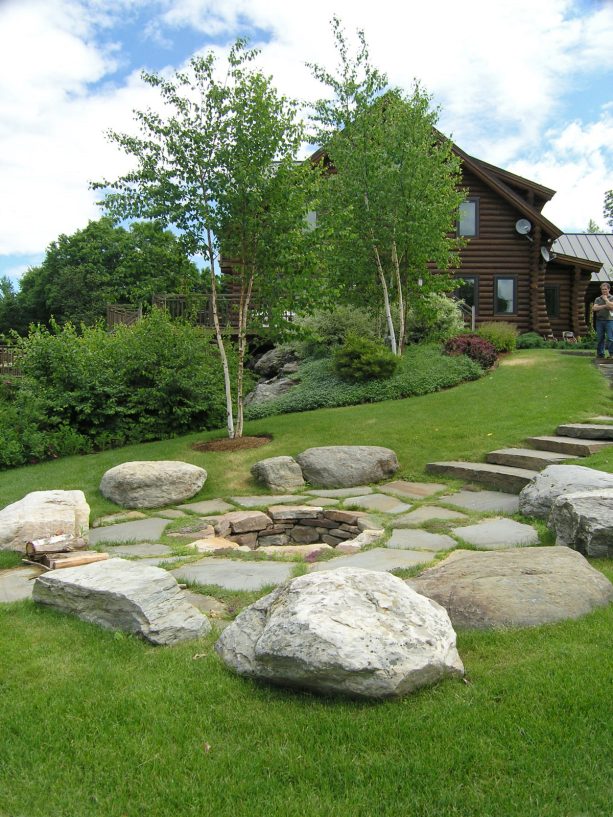 rustic patio with stone landscaping and no chairs