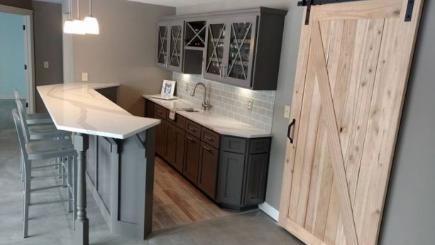 small farmhouse kitchen with a touch of modern style from the gray cabinets and white countertops