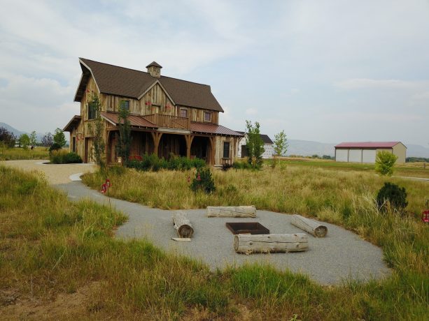 square-shaped sunken fire pit with a cover surrounded by logs
