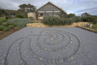 asian rock garden with pea gravel and mexican beach pebbles creating a labyrinth without plants