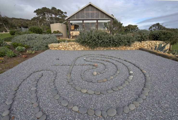 asian rock garden with pea gravel and mexican beach pebbles creating a labyrinth without plants