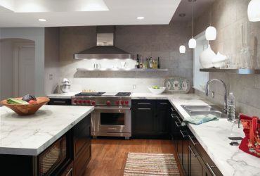 dark kitchen cabinets with light laminate countertops balanced by the gray backsplash