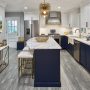 gray ciudad kitchen floor tile with dark blue cabinets