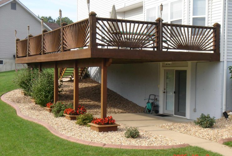 low maintenance gravel under deck landscaping with plants in the perimeter