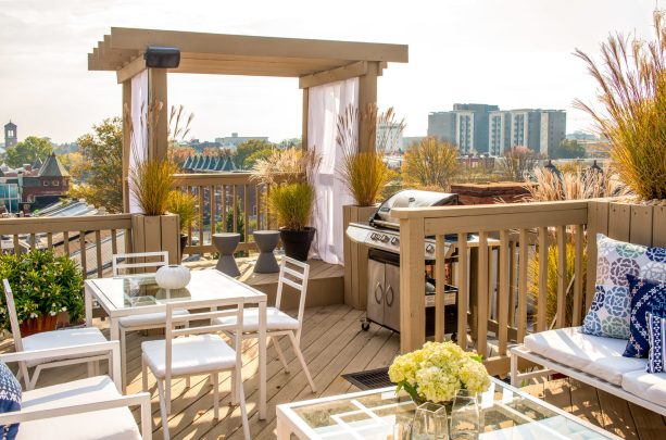 simple and traditional floating deck with a pergola and curtains