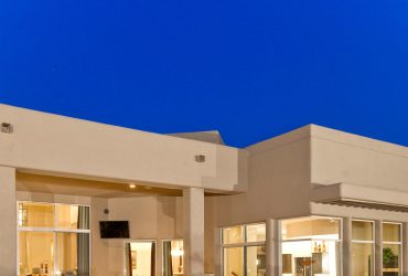 water fountain landscaping in beige color with boulder walls and small rock cover