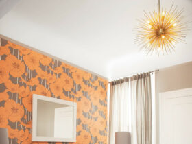 graphic wallpaper accent wall in orange and gray to add a pop of color