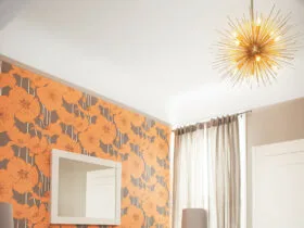 graphic wallpaper accent wall in orange and gray to add a pop of color