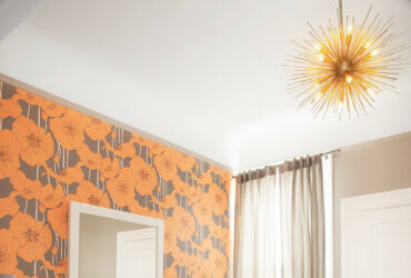 graphic wallpaper accent wall in orange and gray to add a pop of color
