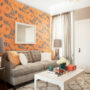 graphic wallpaper accent wall in orange and gray to add a pop of color