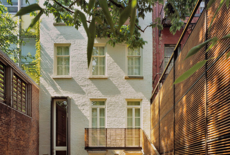 high-screen wall to protect the backyard townhouse patio with rattan furniture